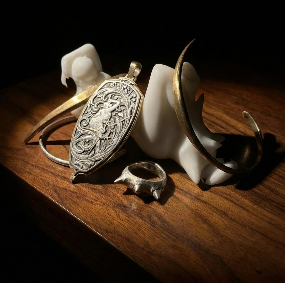 Decorative earrings with intricate designs on a wooden surface