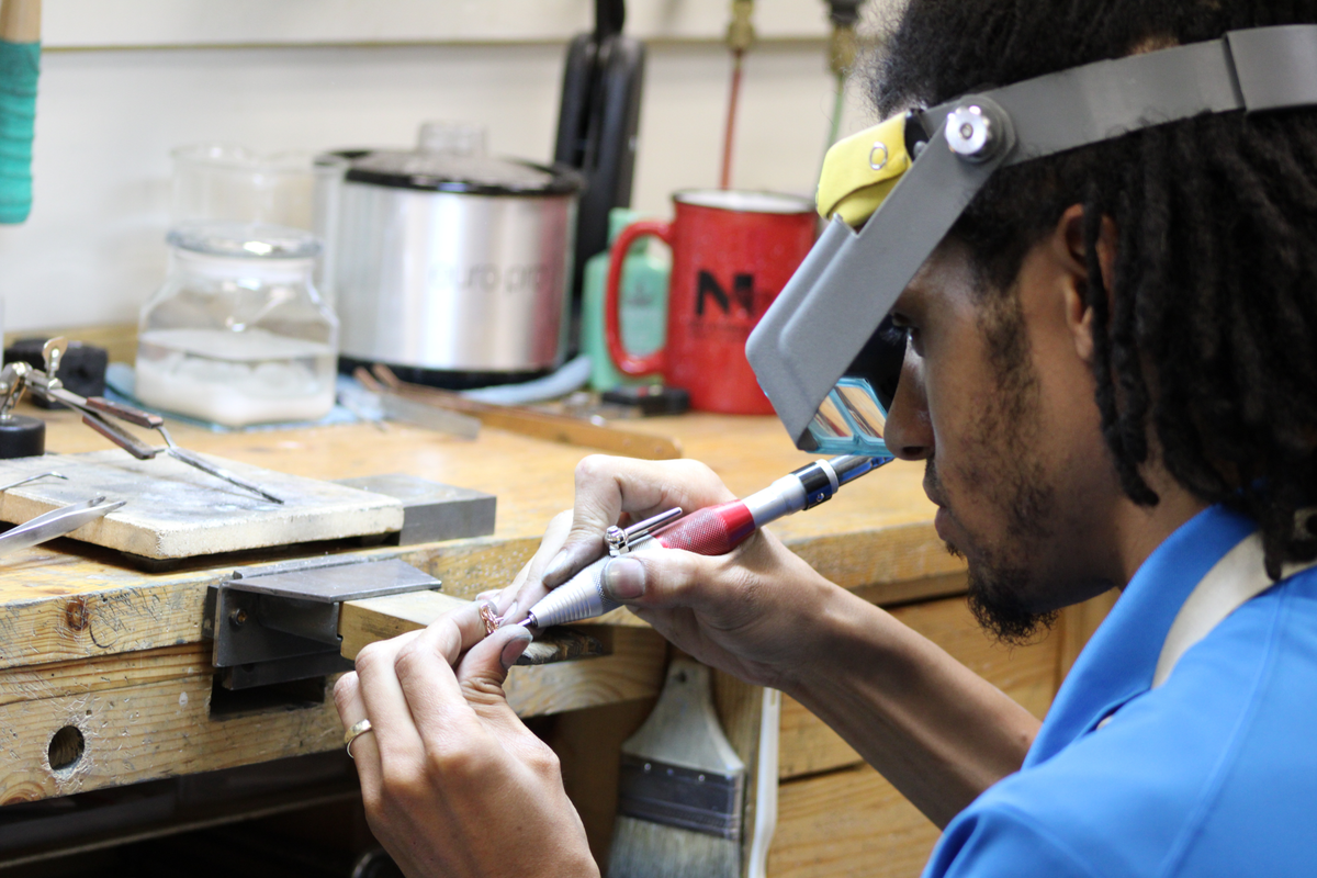 Person working on a project with tools in a workshop setting