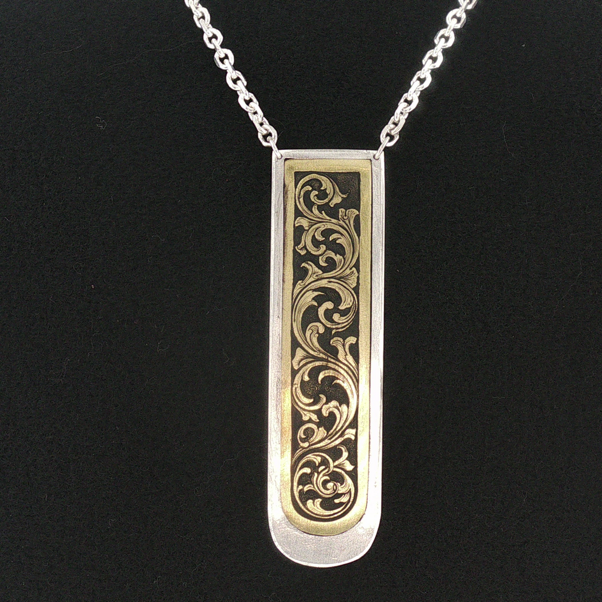 Two hand engraved brass acanthus leaf pendants