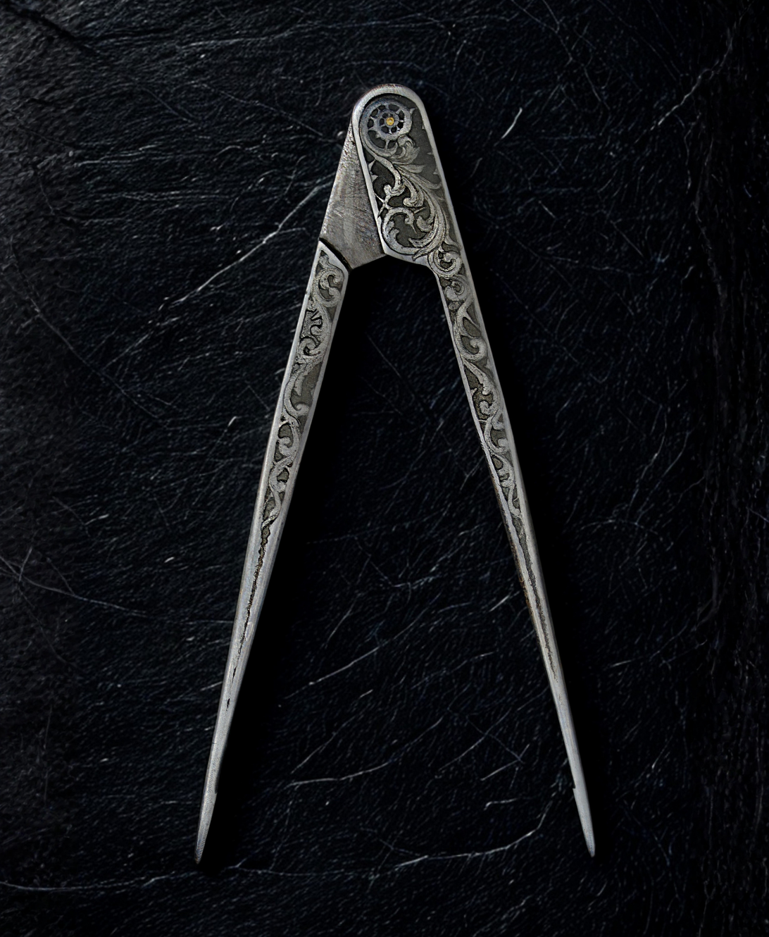 Decorative metal compass on a dark textured surface