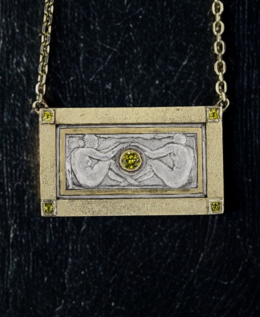 Gold pendant with a central gemstone on a dark background